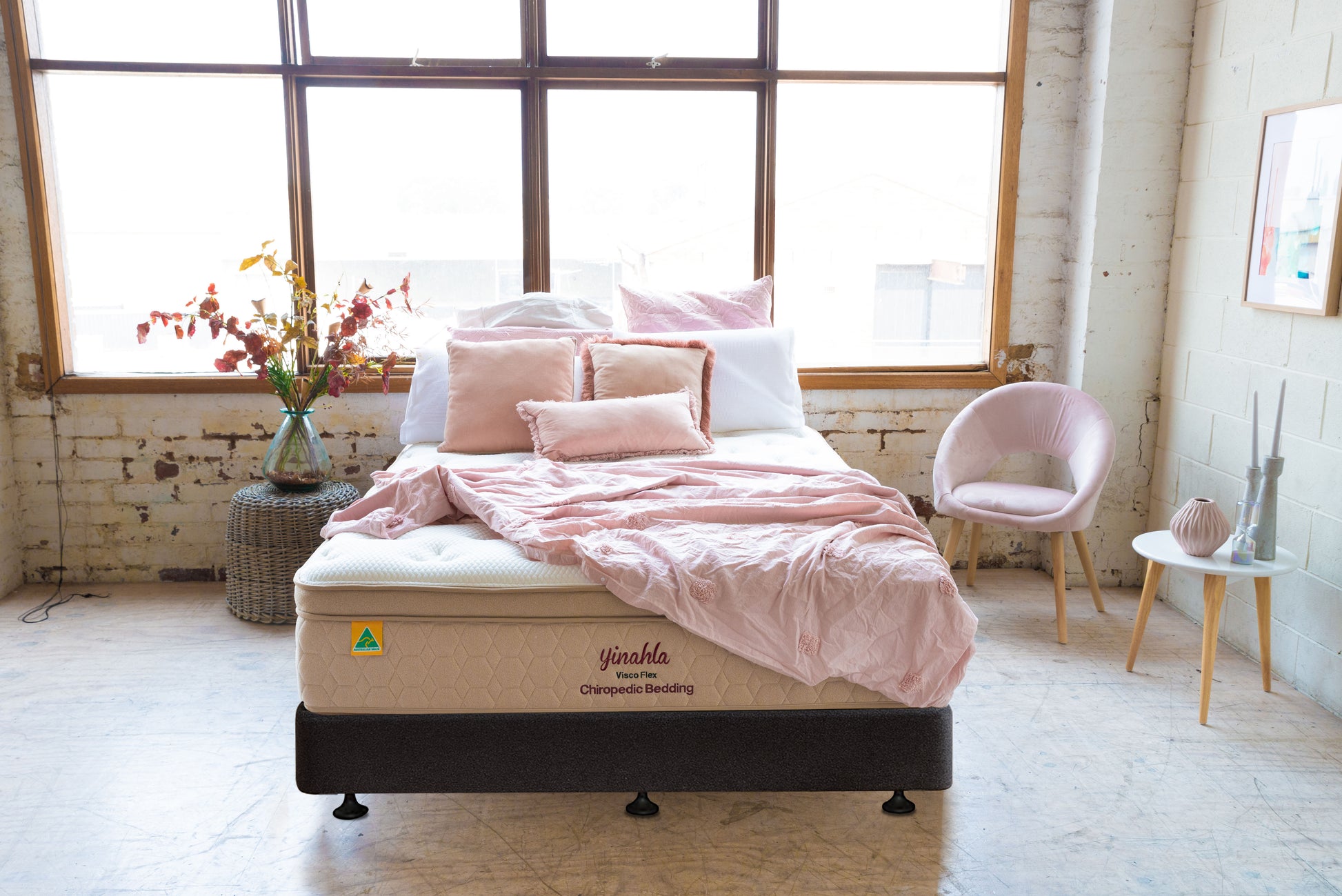 Chic bedroom with Jinahla Visco Flex orthopedic mattress, pink bedding, chair, and natural decor
